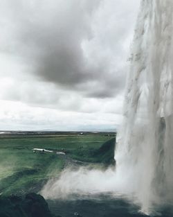 Scenic view of waterfall against sky