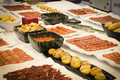 Meat arranged in plates on table