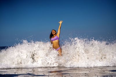 Rear view of woman swimming in sea