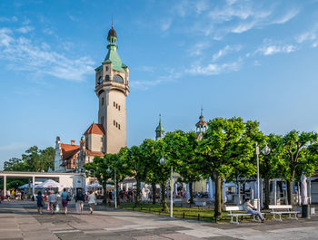 View of clock tower amidst buildings in city