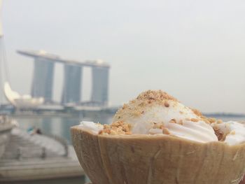 Close-up of coconut milk ice cream against sky