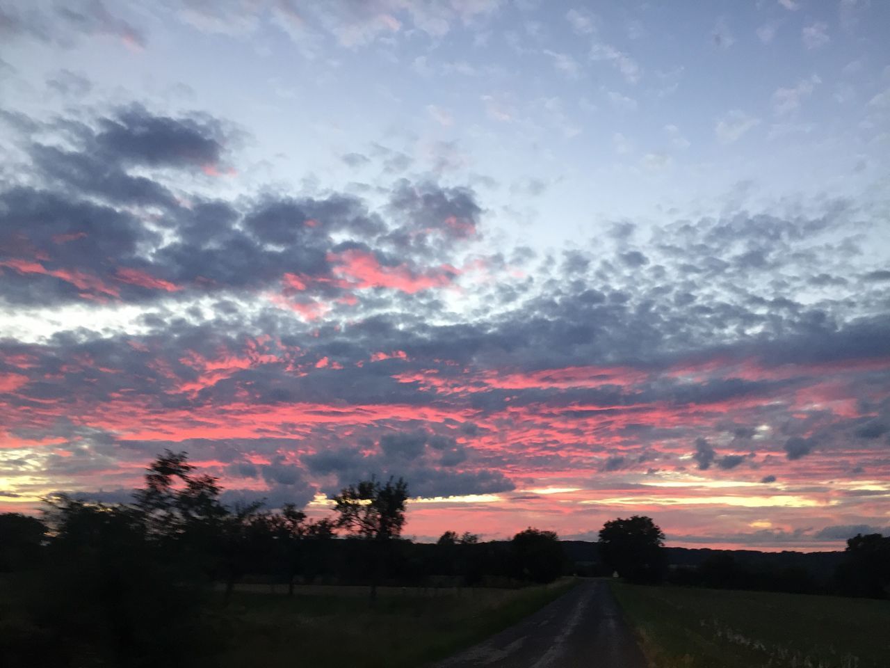 road, the way forward, sky, scenics, nature, sunset, cloud - sky, landscape, beauty in nature, tranquil scene, tranquility, transportation, no people, tree, silhouette, outdoors, day