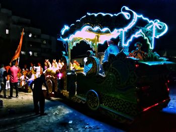 People enjoying illuminated music concert at night