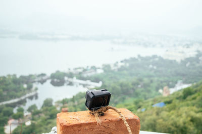 Close-up of coin-operated binoculars against sky