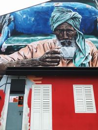 Portrait of a man sitting on window