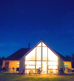 Illuminated built structure against blue sky