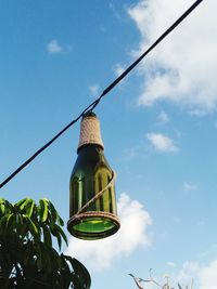 Low angle view of clothesline hanging against sky