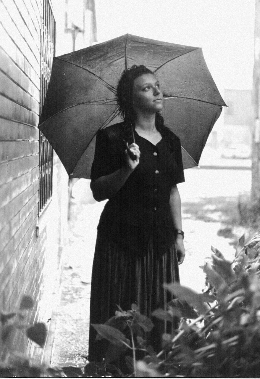 umbrella, rain, sheltering, protection, weather, wet, mid adult, waiting, one person, holding, outdoors, only women, adult, raindrop, adults only, young adult, people, storm, one woman only, under, lifestyles, extreme weather, well-dressed, young women, one young woman only, day, city, beautiful people, thunderstorm, lightning