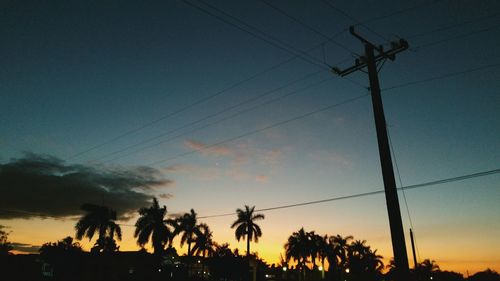 Low angle view of electricity pylon against sky