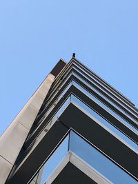 Low angle view of modern building against clear blue sky