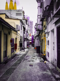 Empty alley amidst buildings in city