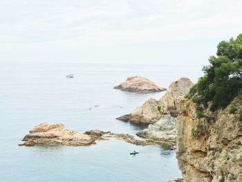 High angle view of rocky shore against sky