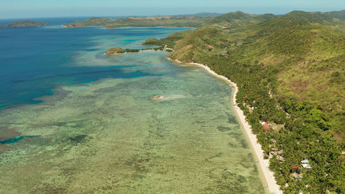 Aerial view tropical island with beach, coral reef and blue lagoon. busuanga, palawan, philippines. 