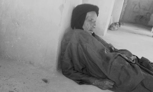 High angle view of man sleeping on wall at home