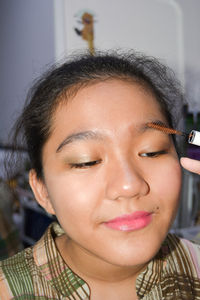 Close-up portrait of young woman with eyes closed