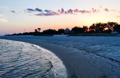 Scenic view of beach against sky during sunset