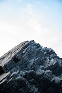 Low angle view of rock formation against sky