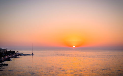 Scenic view of sea against romantic sky at sunset