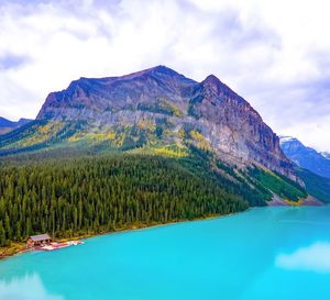 Scenic view of lake by mountains against sky