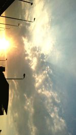 Low angle view of street light against cloudy sky