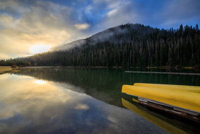 Canoes resting by boat area on calm lake