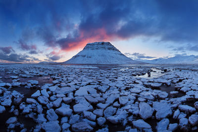 Scenic view of snowcapped mountain against sky during sunset