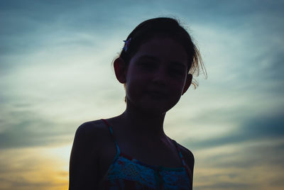 Close-up of young woman against sky