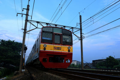 Train on railroad tracks against sky