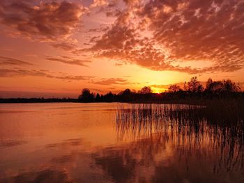 Scenic view of lake against romantic sky at sunset