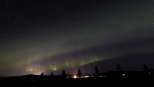 Low angle view of silhouette landscape against sky at night