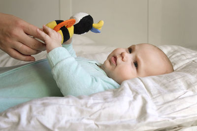 High angle view of baby boy sleeping on bed at home