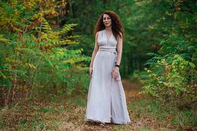 Woman standing in a forest