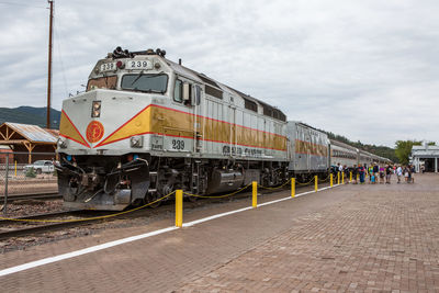 Train on railroad tracks against sky