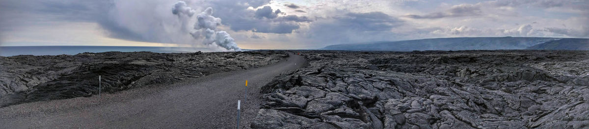 Smoke emitting from volcanic mountain against sky