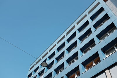 Low angle view of building against clear blue sky in city