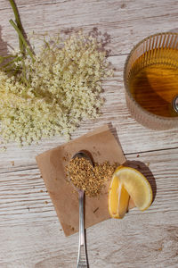 Cup of tea european elderberry, raw and dry flower od the table. the concept of natural healing.