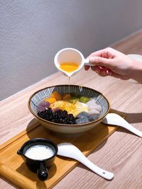 Midsection of person having food on table