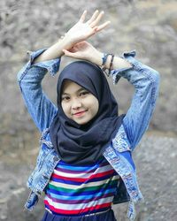 Portrait of smiling boy standing outdoors