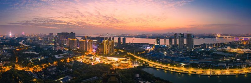 High angle view of illuminated buildings against sky during sunset