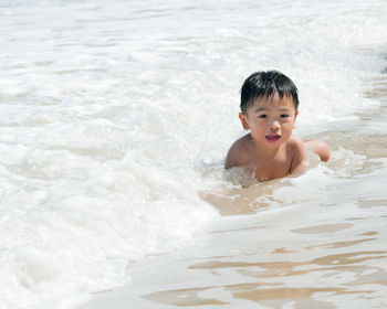 Portrait of smiling boy in water