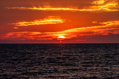 Scenic view of sea against romantic sky at sunset