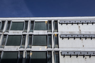 Low angle view of building against clear blue sky
