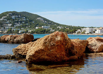 Rocks in front of the beach of santa eulària des riu on the island of ibiza