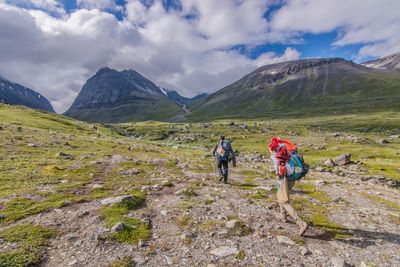 Rear view of people hiking at swedish lapland