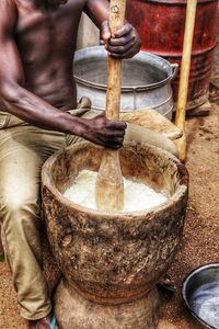 Midsection of man preparing food in kitchen