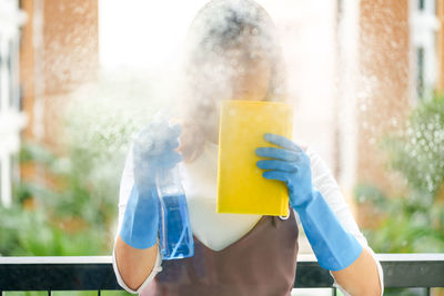 Woman cleaning glass window