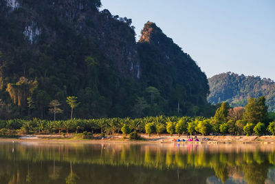 Scenic view of lake by trees against sky in nong thale