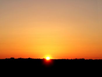 Scenic view of silhouette landscape against romantic sky at sunset