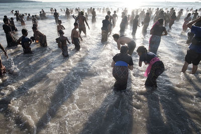 High angle view of people enjoying at beach during winter