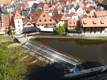 High angle view of houses by river and buildings